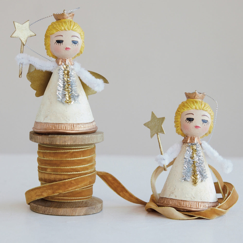 Two resin vintage-reproduction angel ornaments holding star wands, styled with gold velvet ribbon.