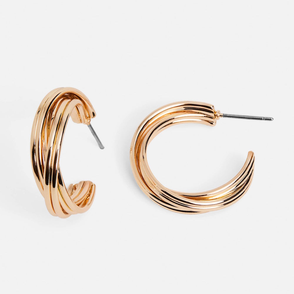 Gold multi-layered hoop earrings with a stacked ring design on a white background.