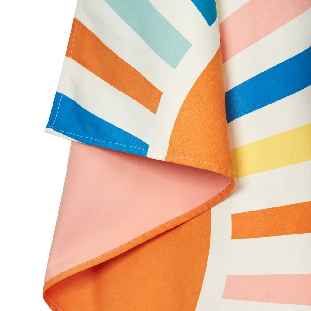 Close-up of a folded towel featuring a colorful pattern of orange, blue, pink, and yellow stripes.