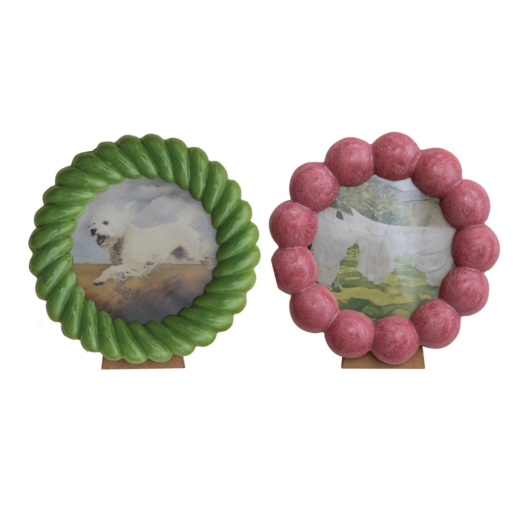 Decorative round resin photo frames in green twist and pink bobble designs for tabletop home decor.