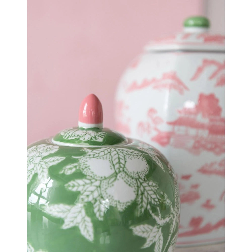 Green and white floral ginger jar with pink finial lid, paired with a red and white chinoiserie jar.