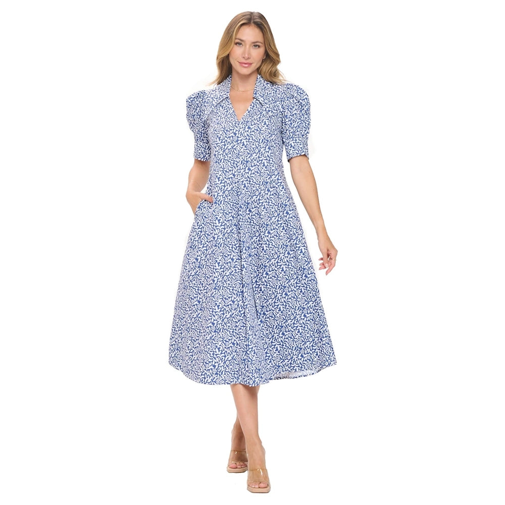 Woman wearing a blue and white floral print midi dress with bubble sleeves and a pleated A-line skirt.