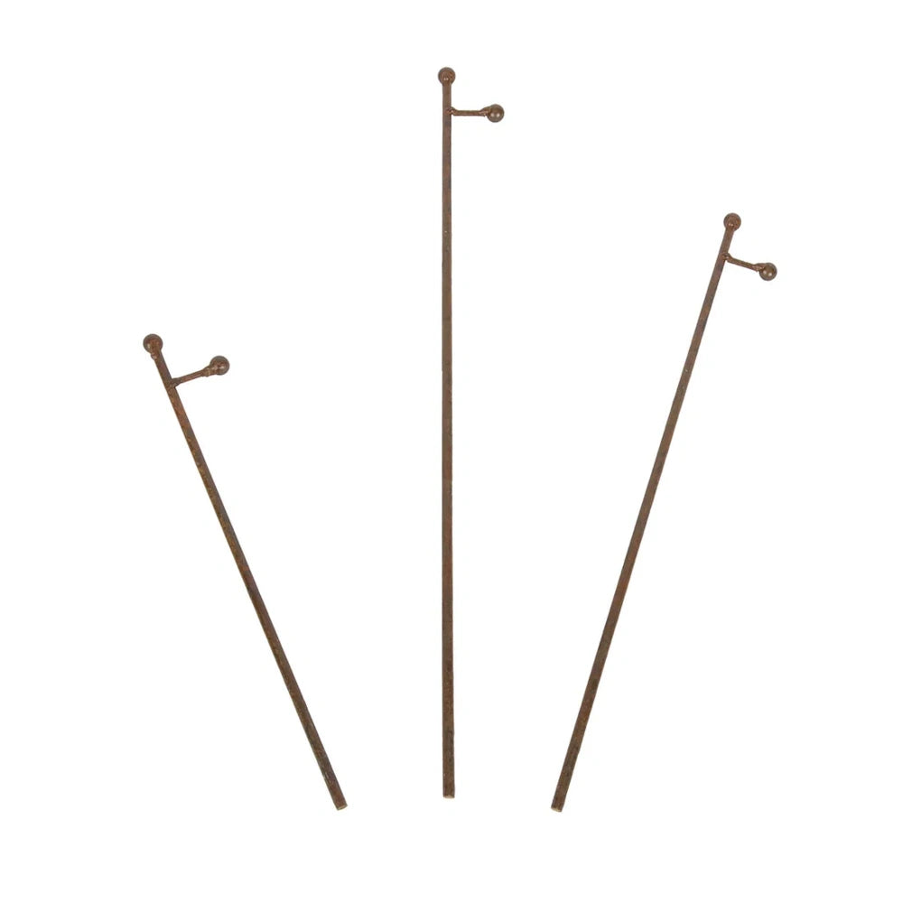 Front view of three rust metal charm display stakes arranged separately.