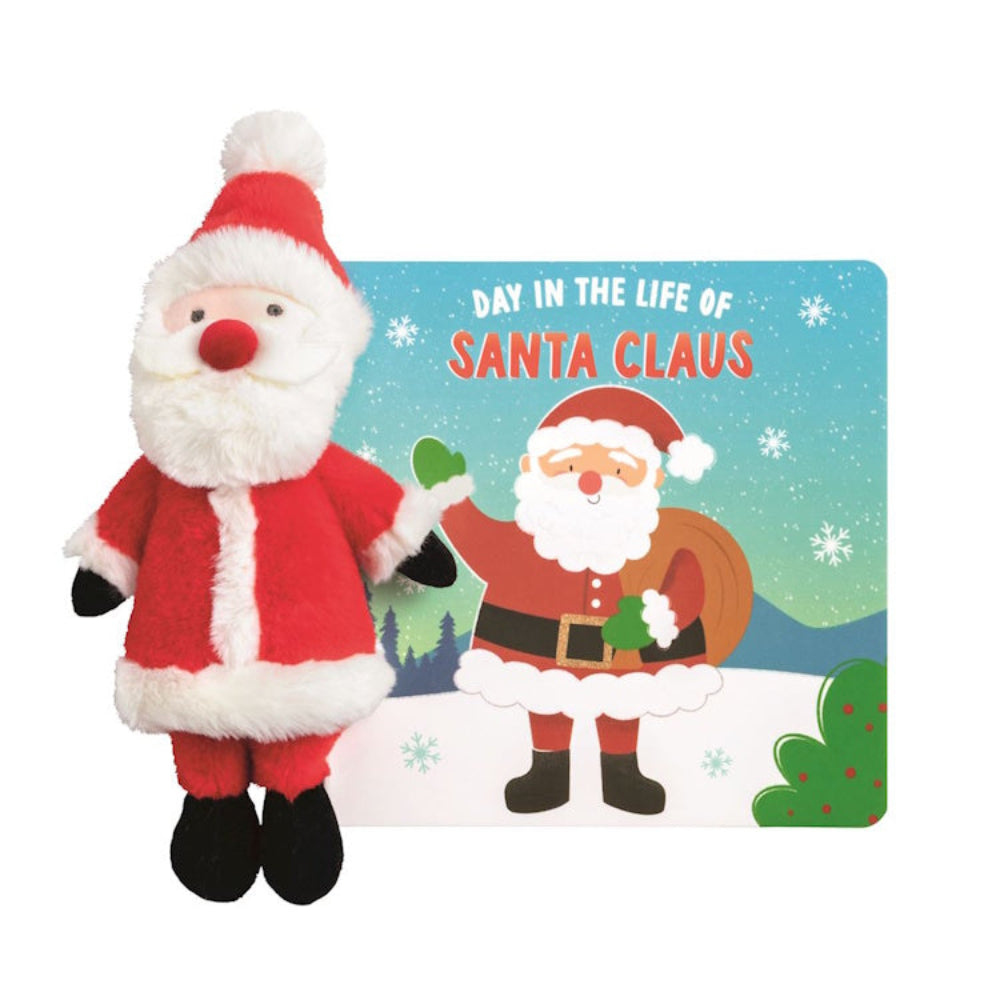 Small plush Santa Claus toy standing next to a "Day in the Life of Santa Claus" storybook.