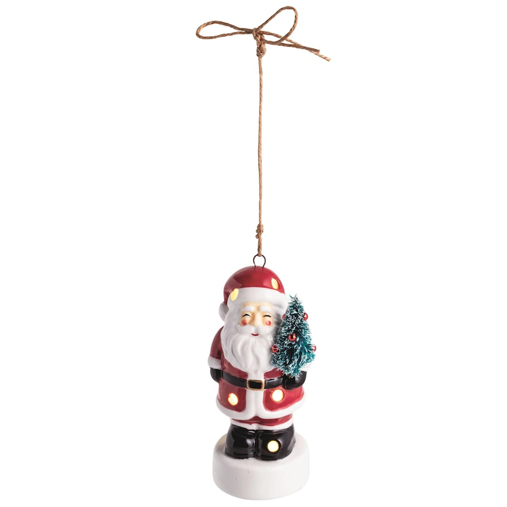 Hanging light-up ceramic Santa Claus ornament holding a small Christmas tree, with twine loop.