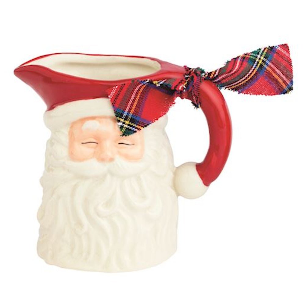 Ceramic Santa Claus pitcher with a white beard, red handle, and red plaid ribbon bow.