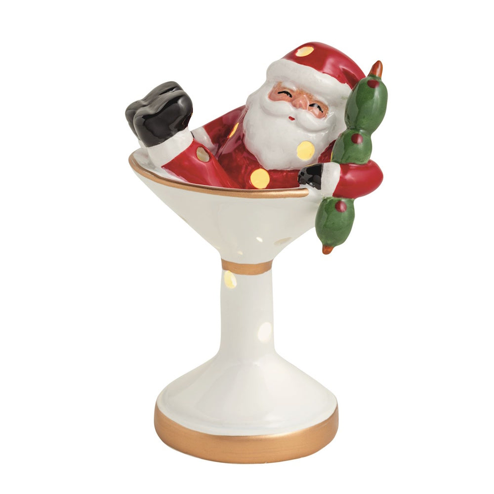 Light-up ceramic figurine of Santa sitting inside a white martini glass holding olive garnishes.