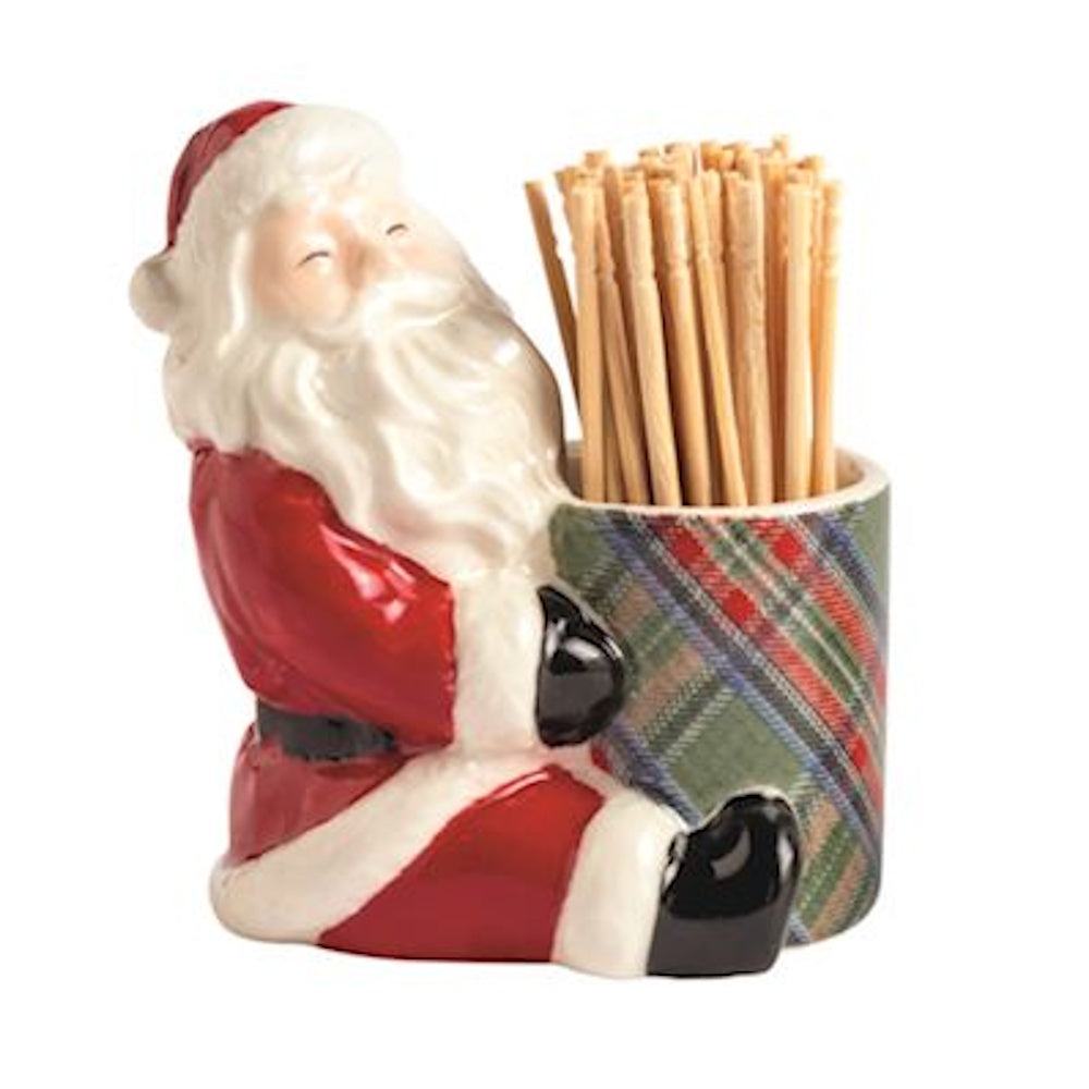 Ceramic Santa Claus figurine leaning against a green plaid caddy holding wooden toothpicks.