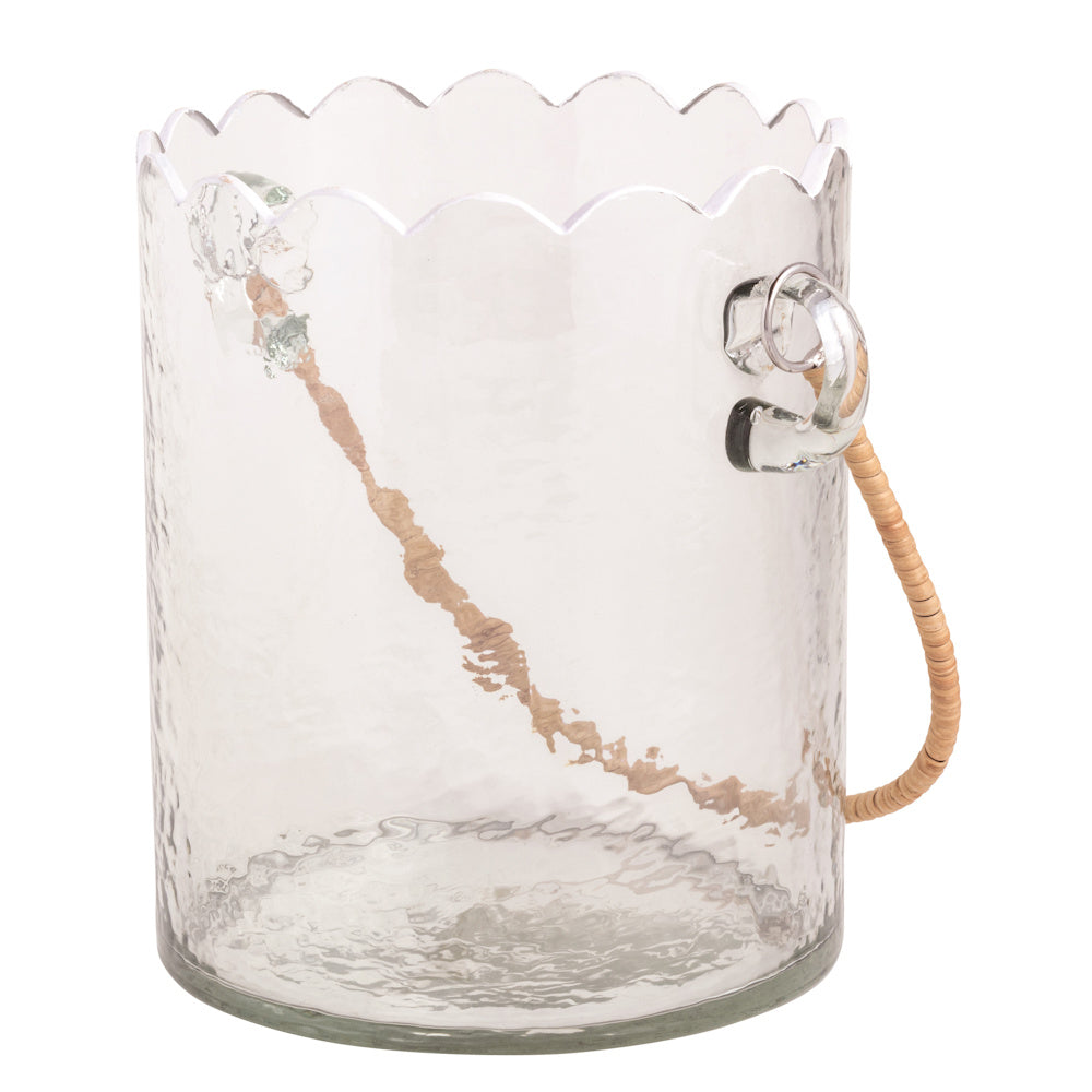 Scalloped clear hand-blown glass ice bucket with a textured finish and woven rattan handle on white background.