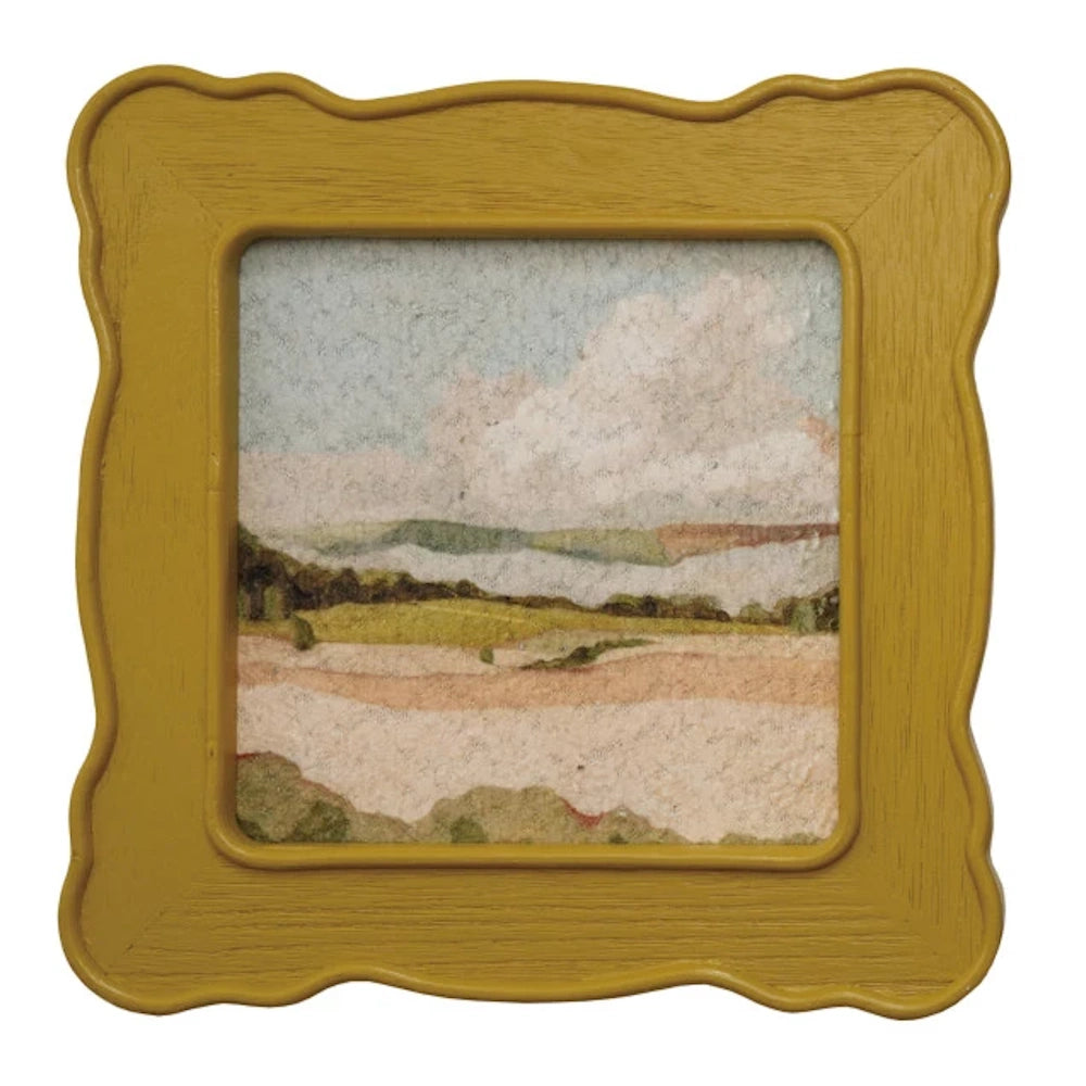 Small landscape painting of hills and clouds in a wavy, mustard yellow vintage-style frame on a white background.