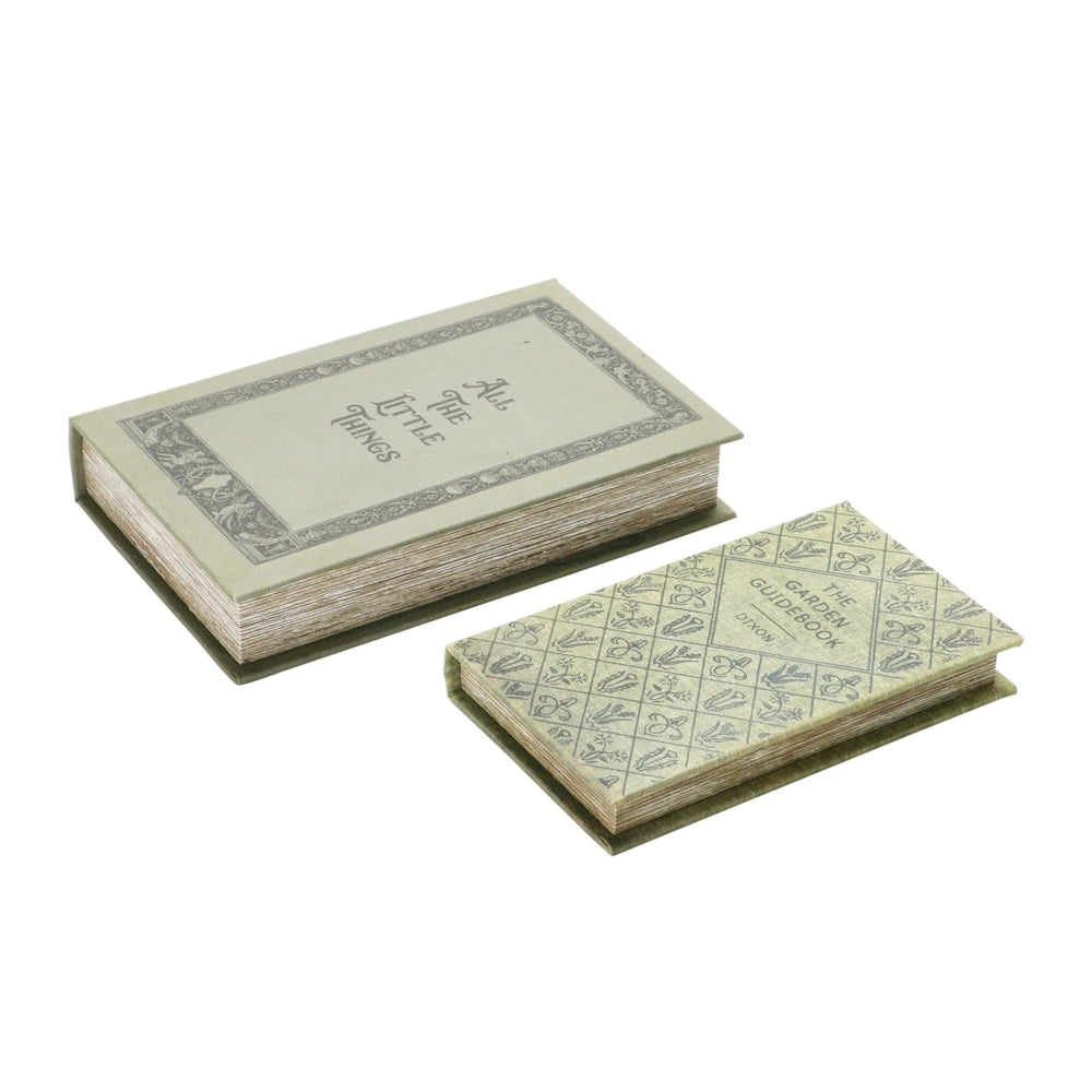 Two vintage-style green canvas book storage boxes featuring decorative botanical prints and "All The Little Things" text.