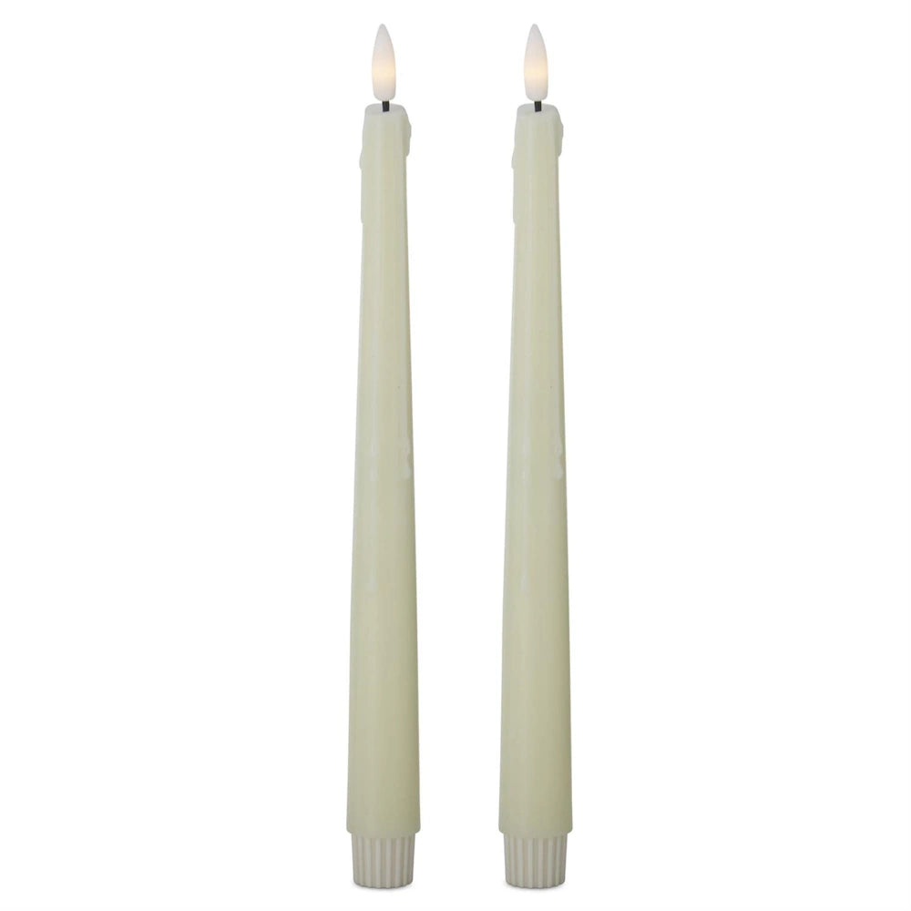 Two cream-colored LED taper candles with faux wax drips and glowing, flame-shaped tips.