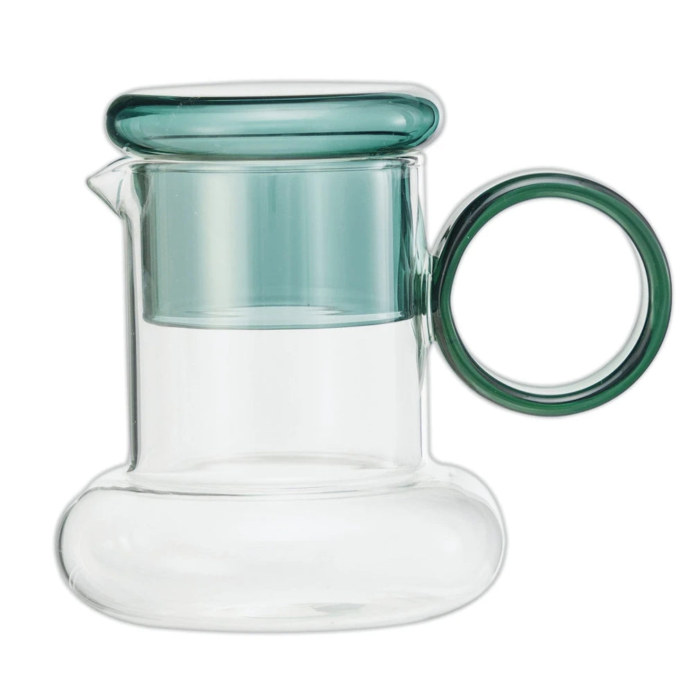 Clear glass carafe with a wide base, a round green handle, and a matching green glass cup resting on top.