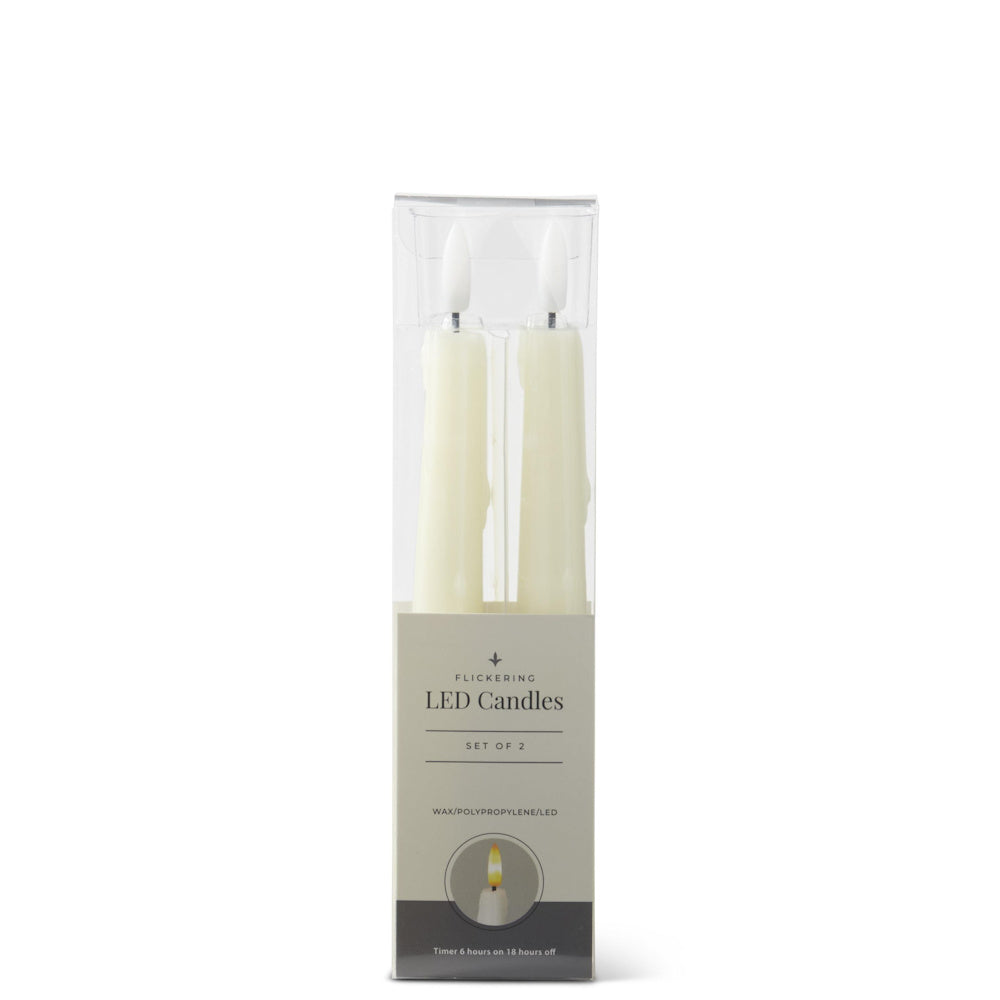 A set of two cream, flickering LED taper candles inside their clear retail packaging.