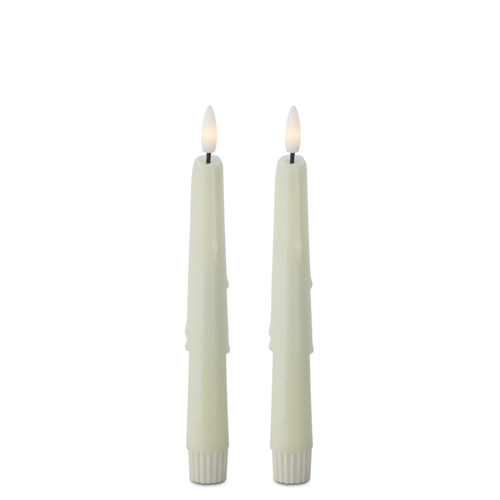 Two cream, flame-shaped LED taper candles with faux dripping wax effects on a white background.