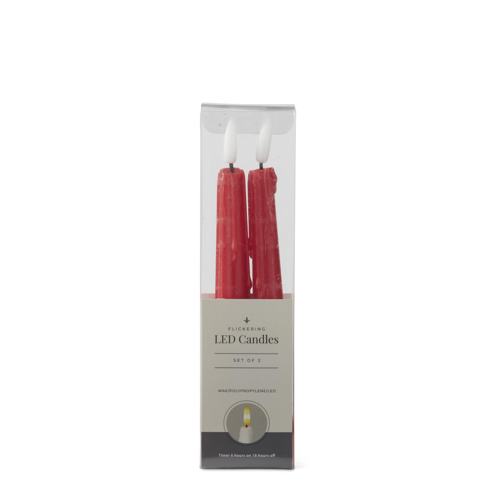 A set of two red dripping LED taper candles inside clear plastic packaging on a white background.