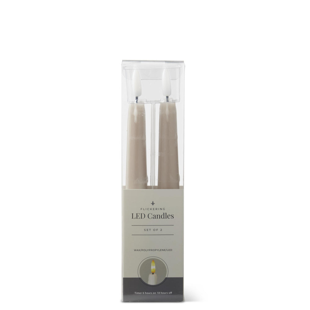 A set of two taupe flickering LED taper candles in clear packaging.