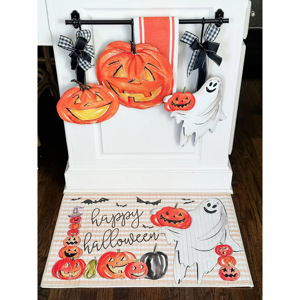 Halloween porch display with jack o lantern and ghost stakes in an urn next to pumpkins and a lantern.