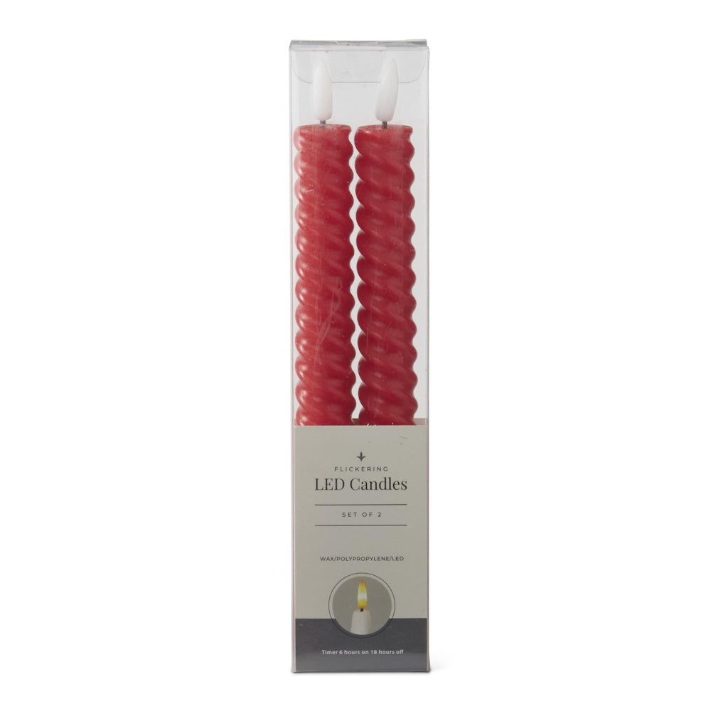 A set of two red spiral LED taper candles inside their clear retail packaging on a white background.