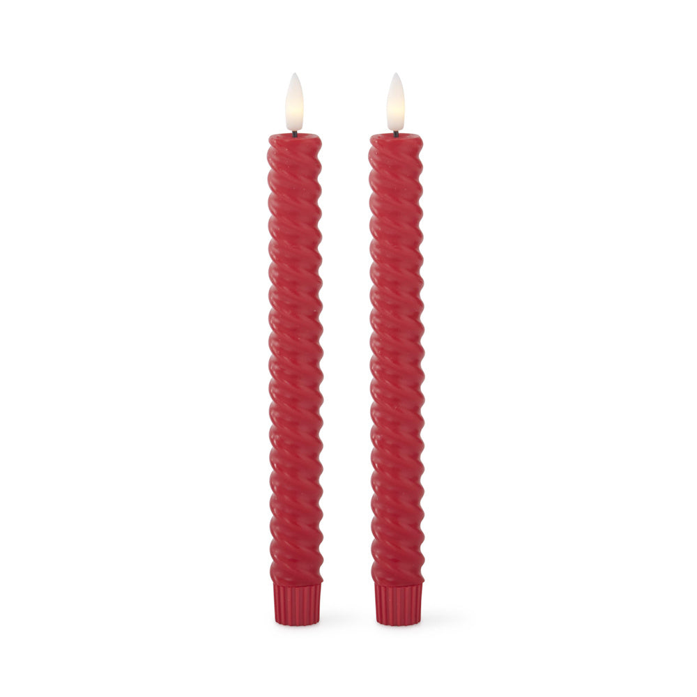 Two tall, spiral-molded red taper candles with glowing faux flames standing side by side.