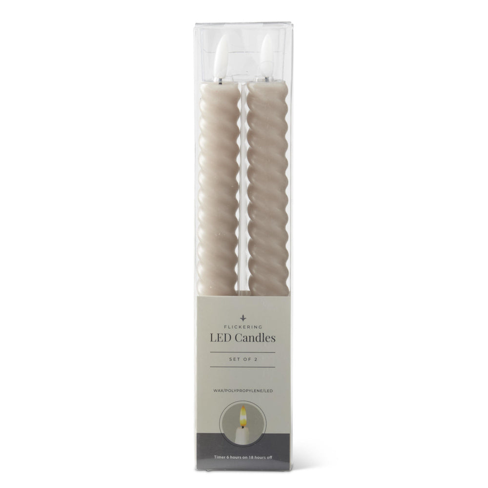 A set of two taupe, spiral-twisted flickering LED taper candles in their original box packaging.