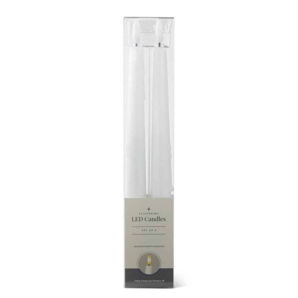 A set of two white flickering LED taper candles in clear plastic packaging.