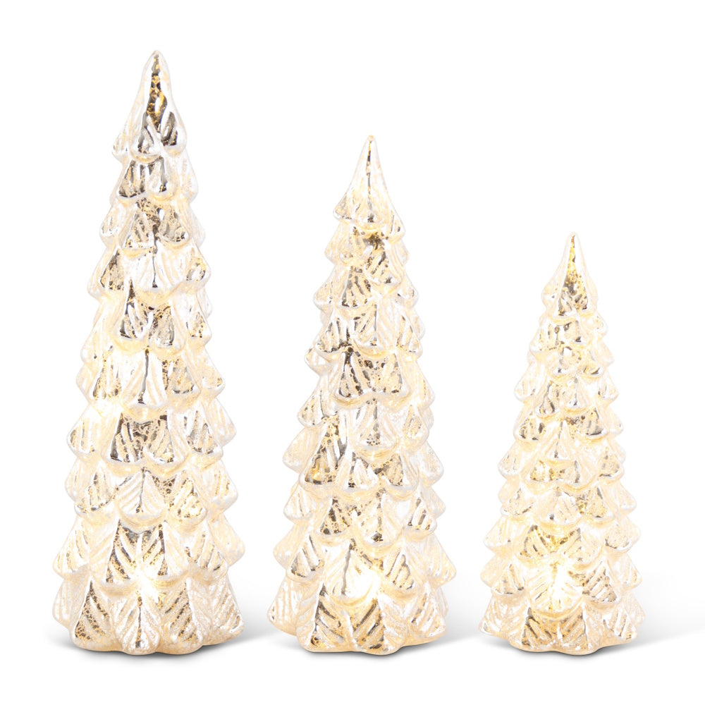 A set of three lit silver mercury glass tree figurines in varying heights with glitter details.