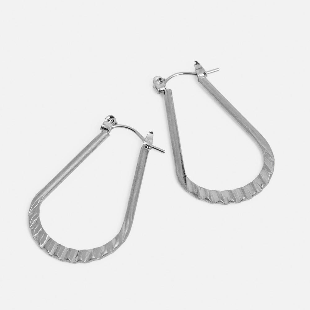 Silver crinkle-textured teardrop dangle earrings. Minimalist metallic jewelry on a plain white background.