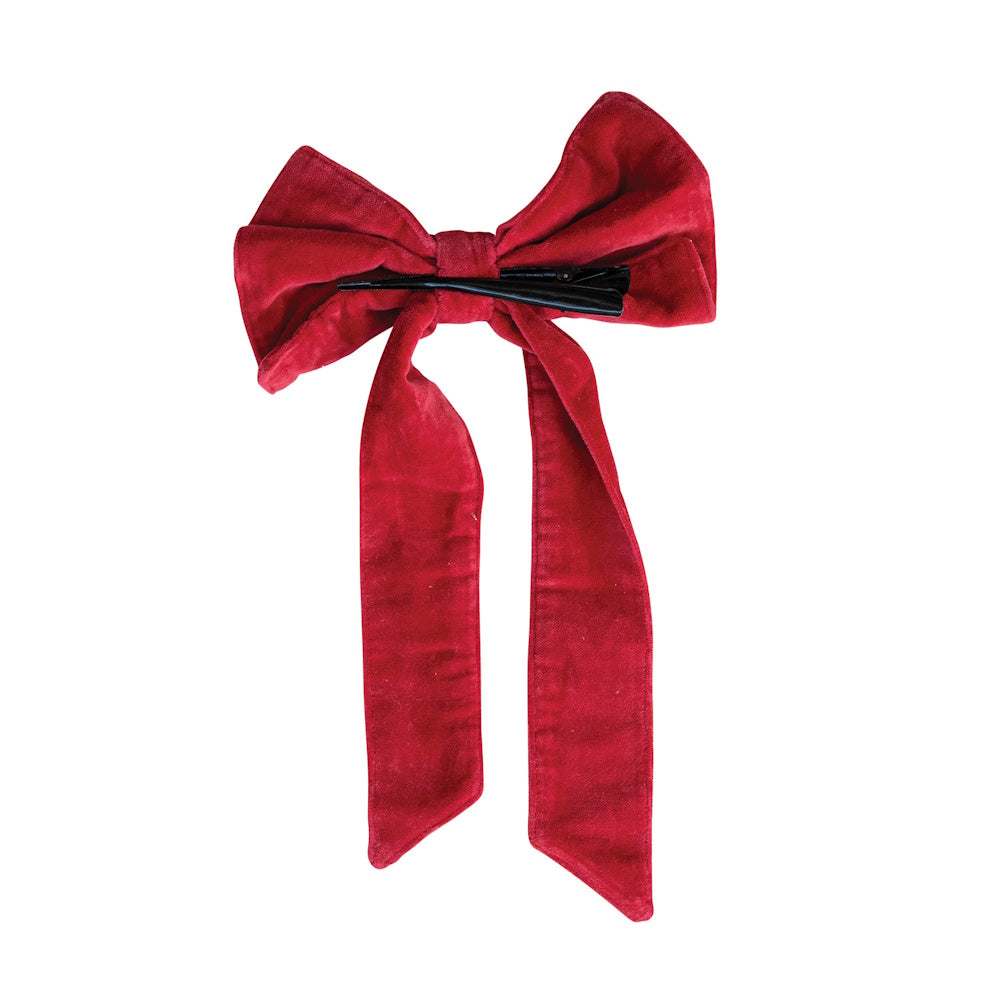 Small red cotton velvet hair bow with short ribbons and a black clip on the back.