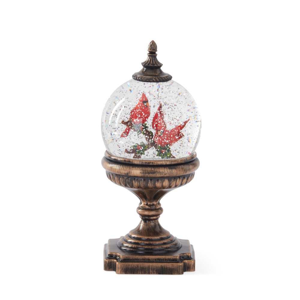 Small cardinal water-spinning LED snow globe with a timer, featuring two red cardinals on a branch atop an ornate bronze pedestal base.