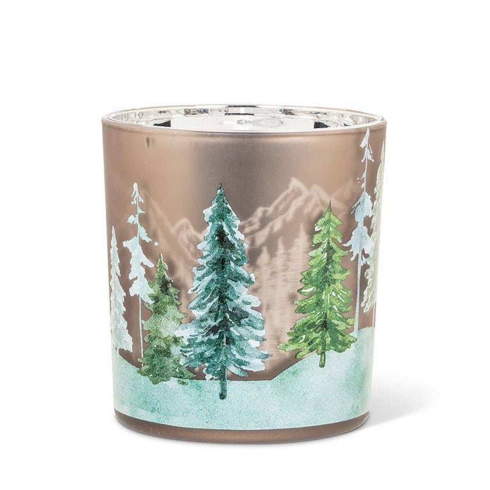 Glass votive candle holder featuring snowy pine trees and a mountain background.