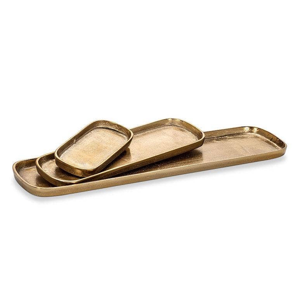 Set of three nested brass metallic rectangular catchall trays stacked on a white background.