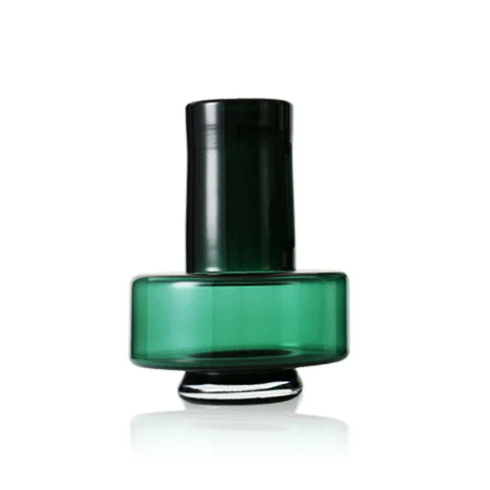 Front view of a short, dark green glass vase with a wide cylindrical body and narrow neck.
