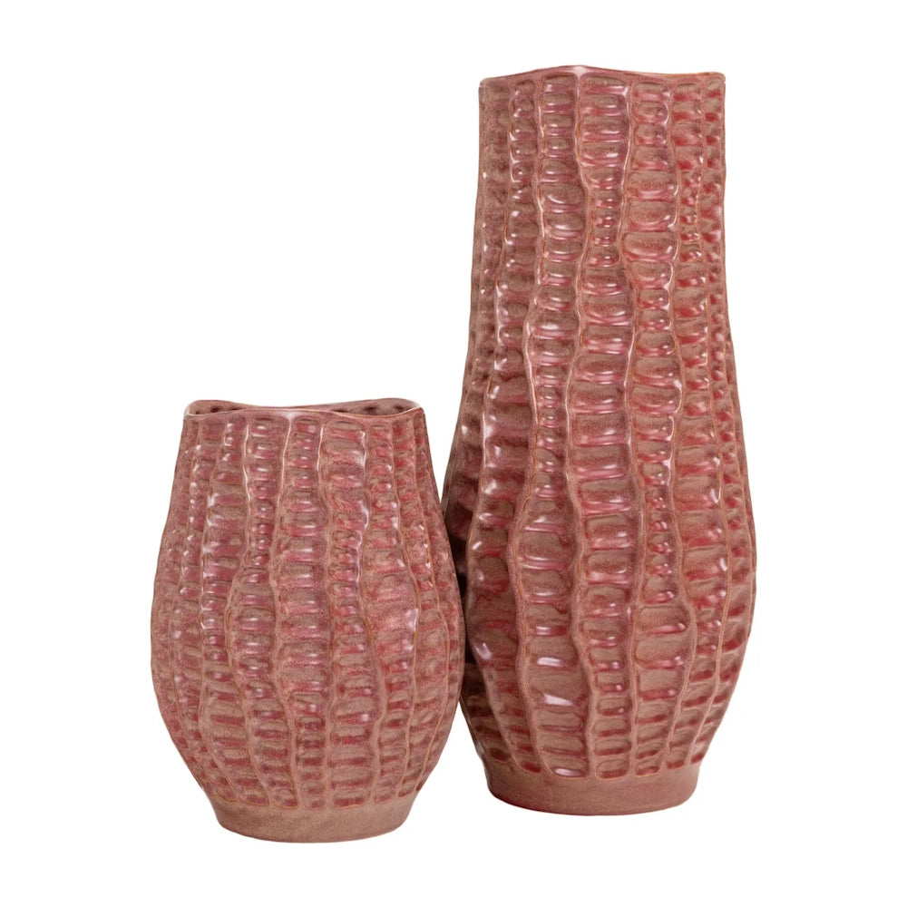 A pair of textured, dusty rose-pink ceramic vases in different heights with a ribbed, organic pattern.