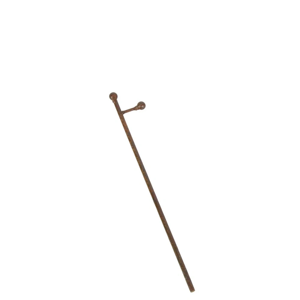 Front view of a small rust metal charm display stake with a single arm.