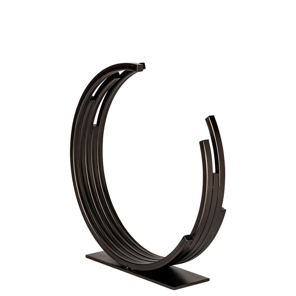 Modern bronze crescent sculpture with concentric metal rings on a rectangular base for home decor.