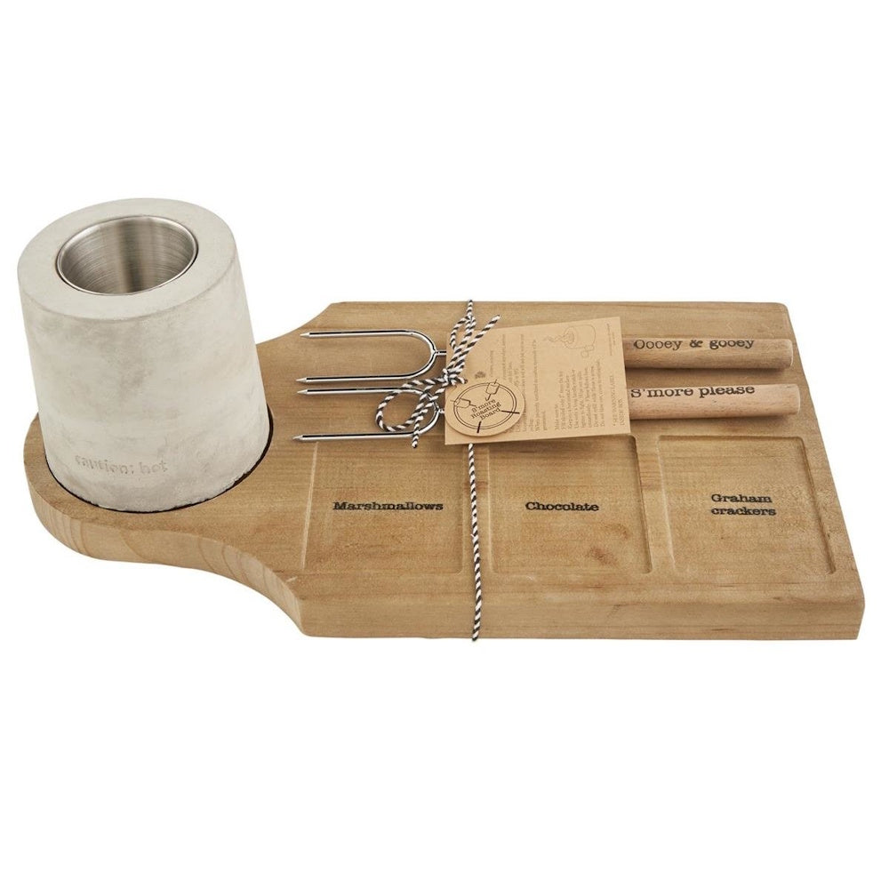 Wooden s'mores roasting board with labeled compartments, two forks, and a concrete personal fire pit bowl.
