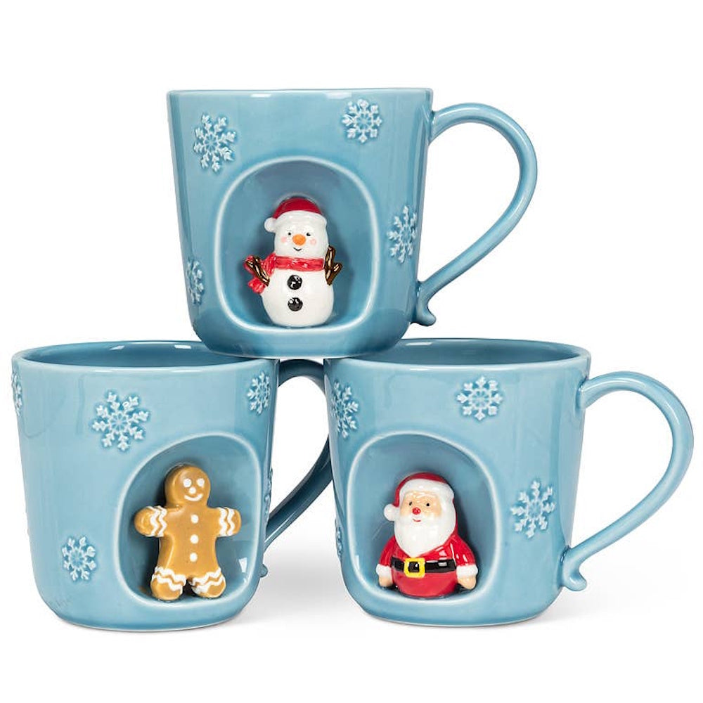 Three light blue snowflake mugs, each featuring a recessed alcove with a snowman, gingerbread man, or Santa.