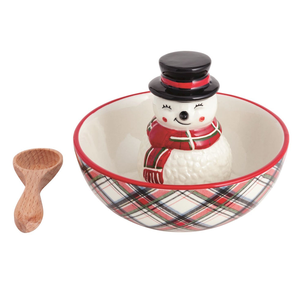 Tartan plaid candy bowl with a center snowman figurine and small wooden spoon.