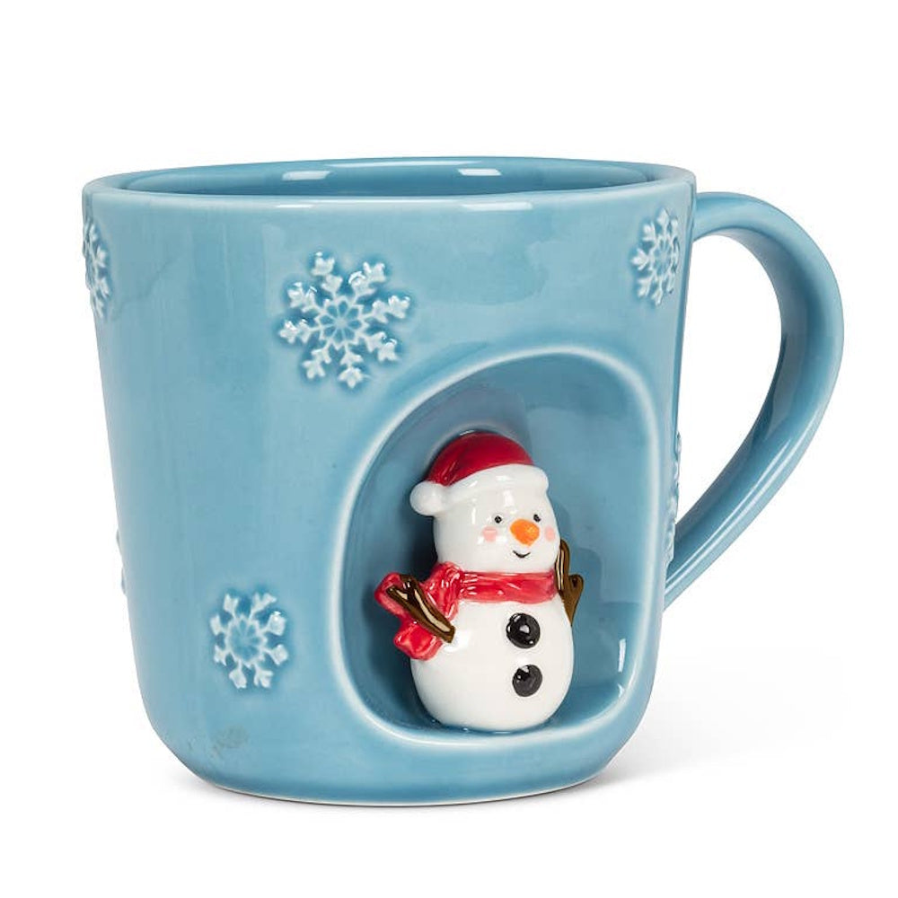 Light blue ceramic mug decorated with snowflakes and a 3D snowman figure inside a side recess.