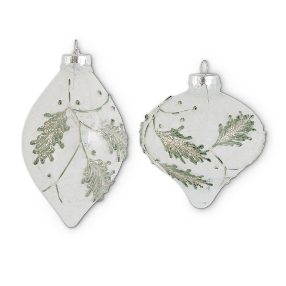 Two snowy clear glass onion and teardrop ornaments decorated with green leaf designs.
