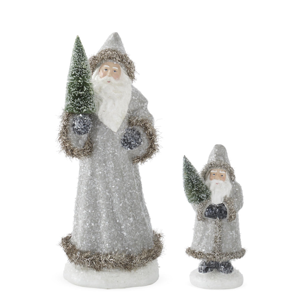 Set of 2 Santa figurines in snowy gray coats trimmed with tinsel, each holding a green bottle brush tree.