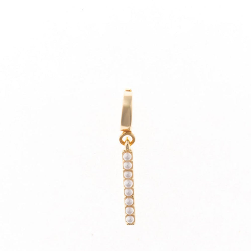 Gold letter 'I' charm studded with small white faux pearls on a plain white background.