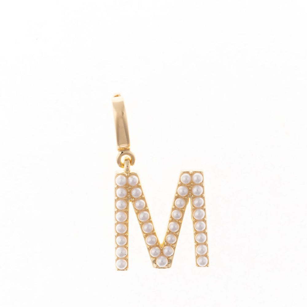 Gold letter 'M' charm studded with small white faux pearls on a plain white background.