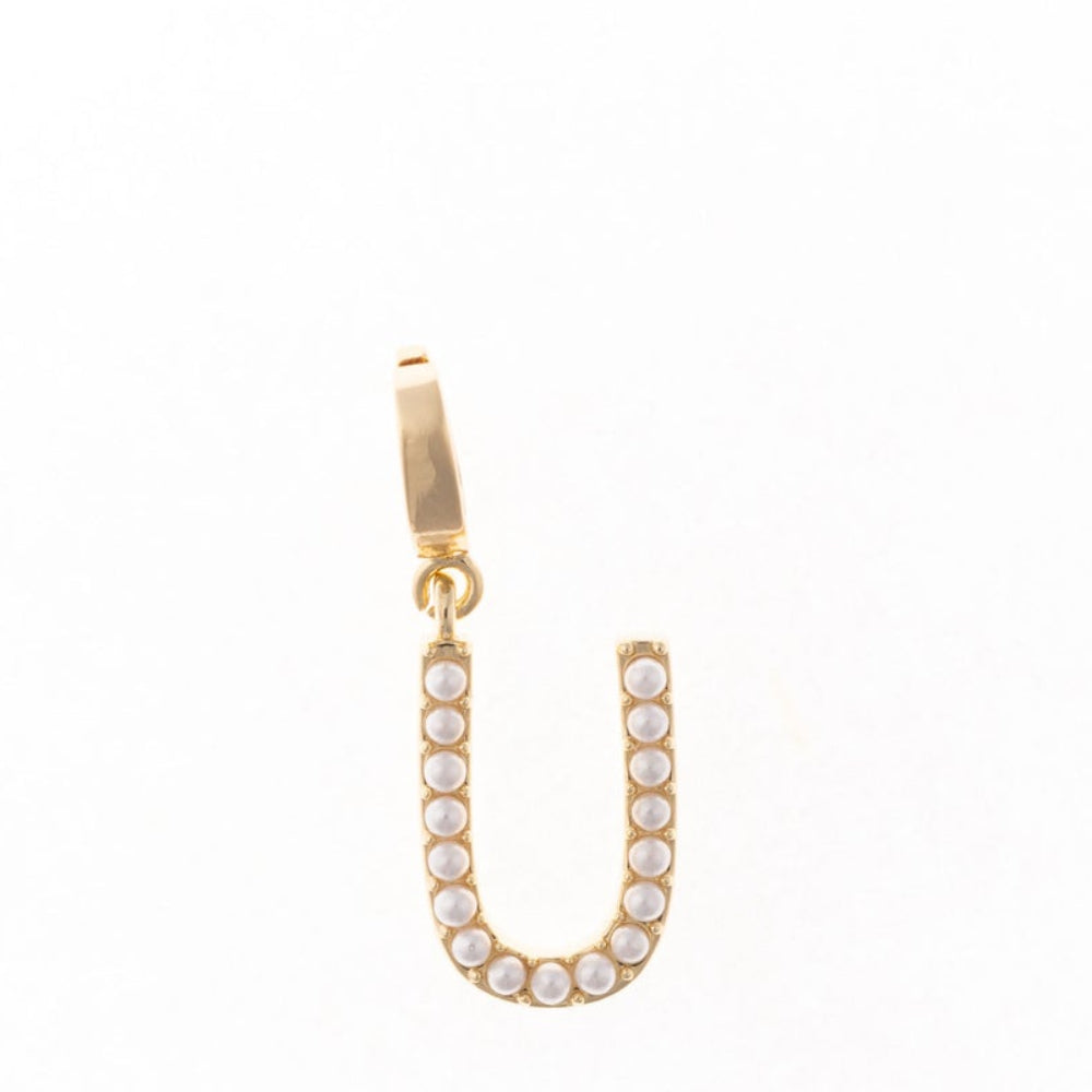 Gold letter 'U' charm studded with small white faux pearls on a plain white background.