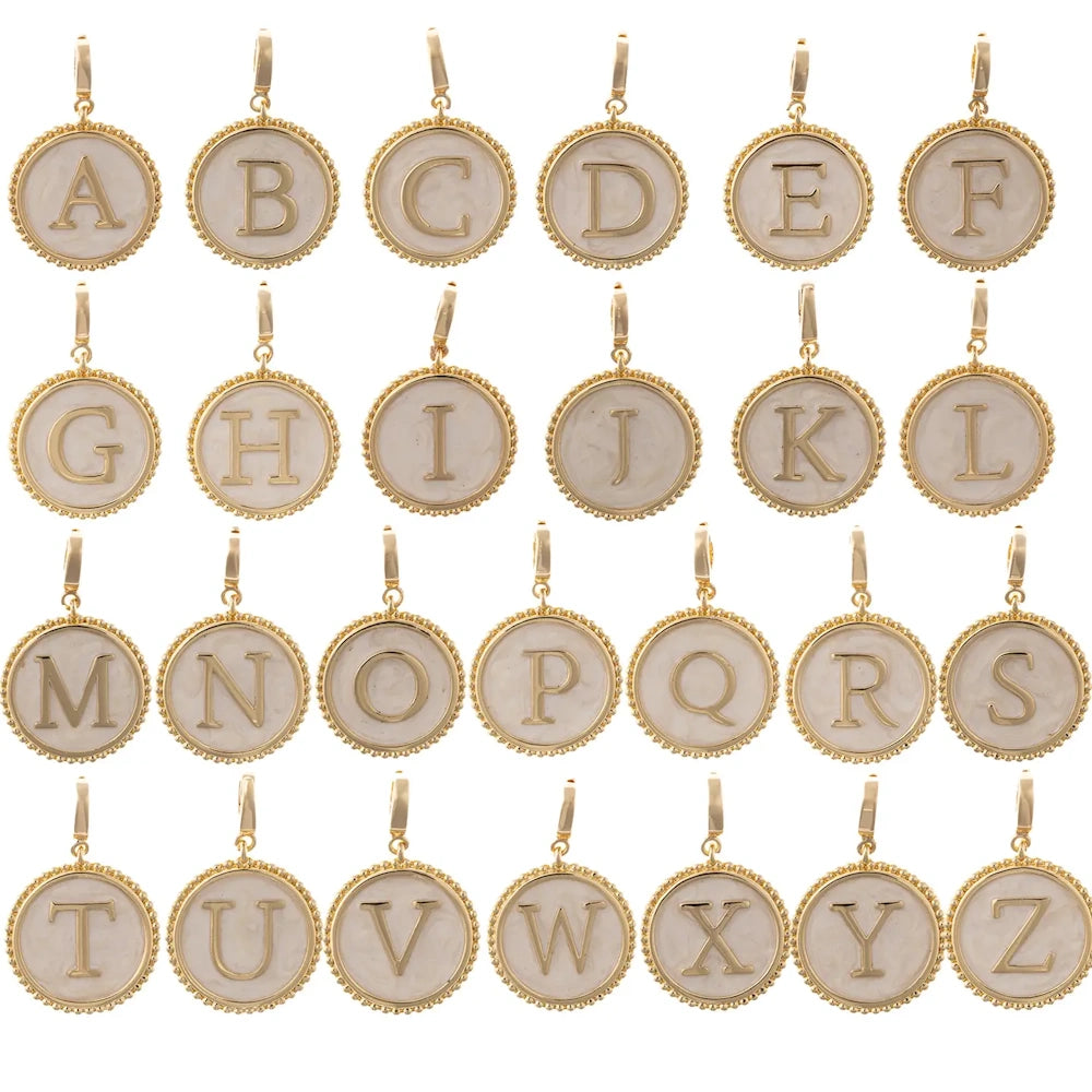 Collection of round gold pendant charms with mother-of-pearl inlay, each featuring a capital letter from A to Z.
