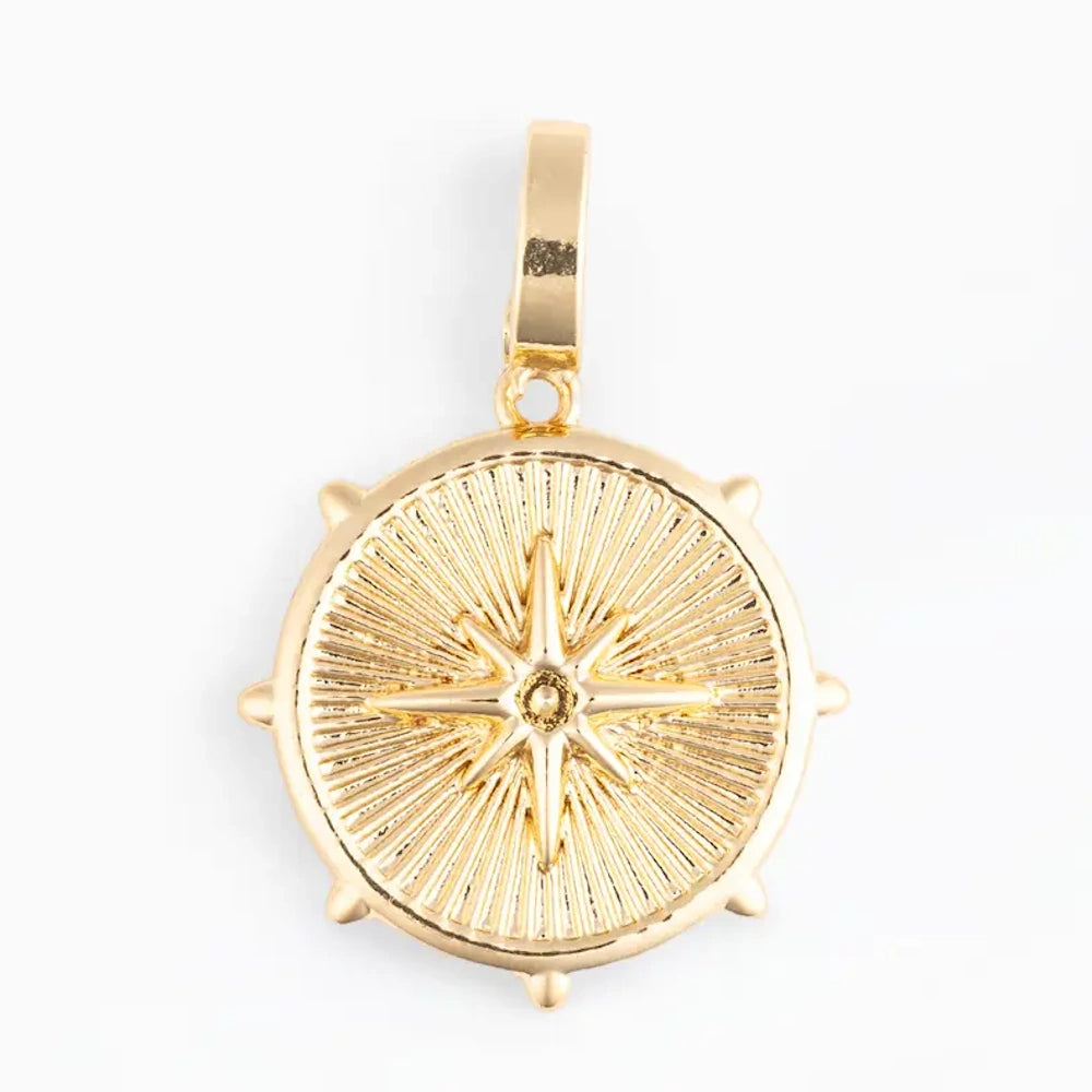 Gold coin-shaped pendant charm featuring a central starburst design with textured ray details.