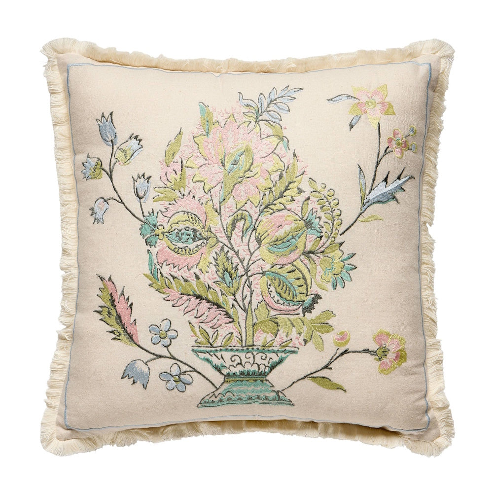 Embroidered floral throw pillow with pastel botanical design, fringe trim, and cream fabric for home decor.