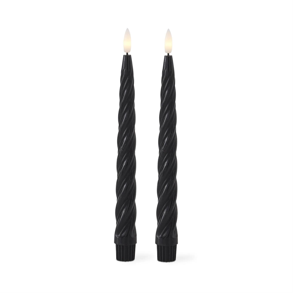 Two black, spiral-textured LED taper candles with glowing, flame-shaped tips standing on a white background.