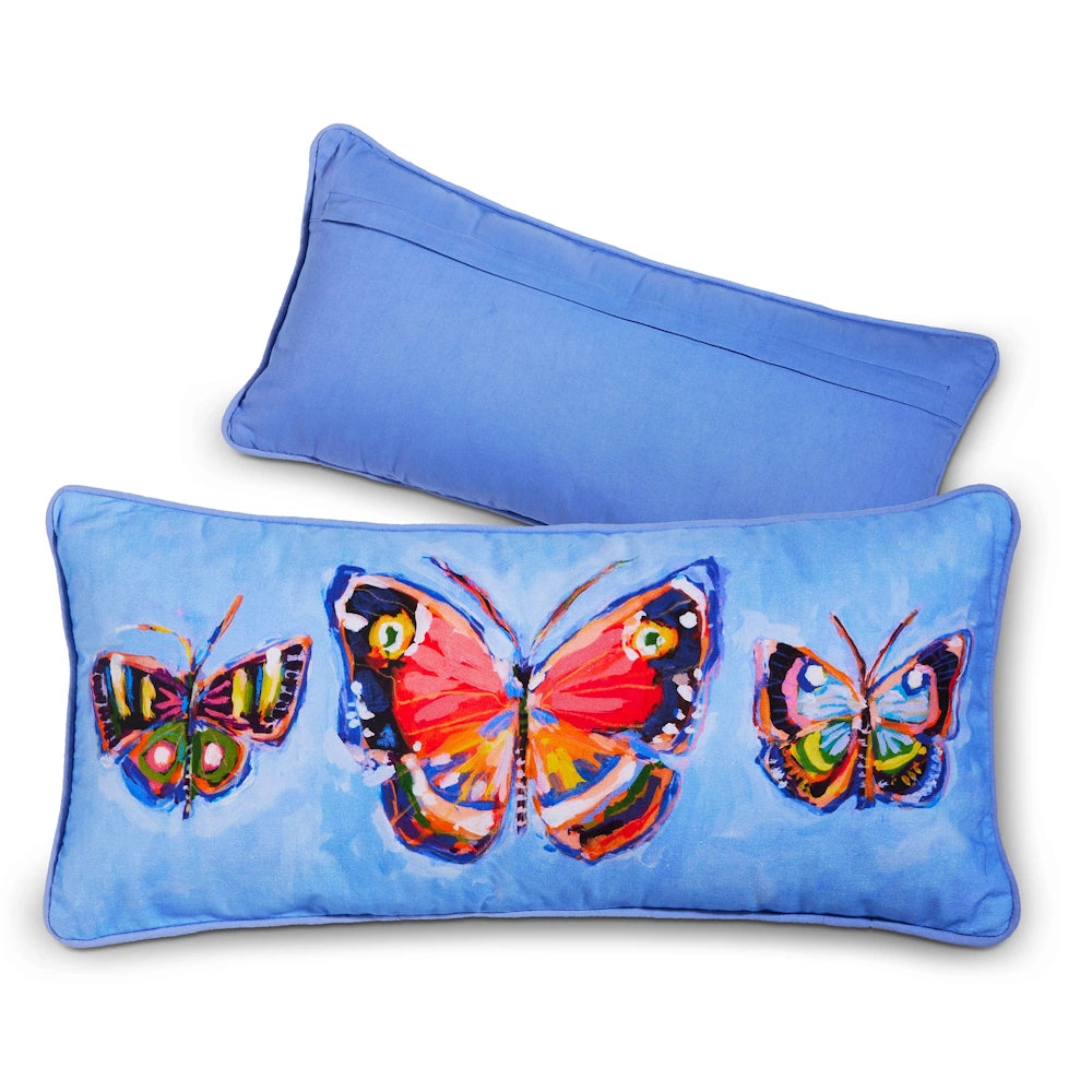 Two blue lumbar pillows: one features a colorful, painterly butterfly design, while the other shows a plain blue back.
